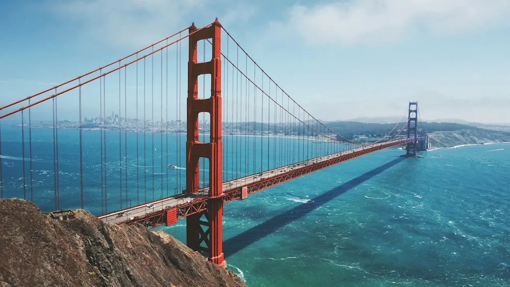 The Golden Gate Bridge spanning San Francisco Bay with the city skyline in the distance