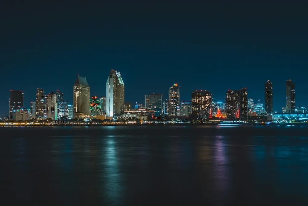 The San Diego skyline at night reflected in the bay